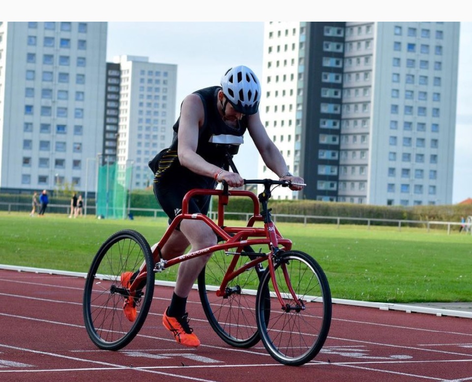 Ed is pictured running on an outdoor track on his Frame Running bike.